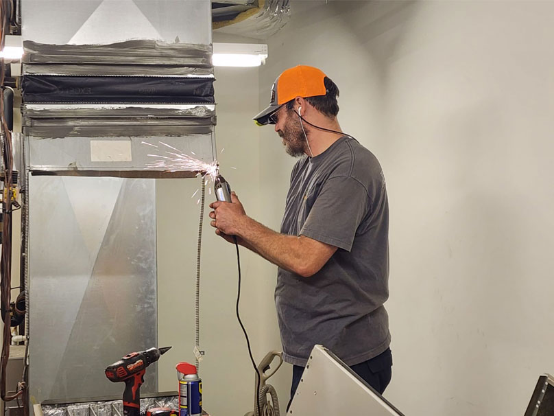 Woody technician working on furnace