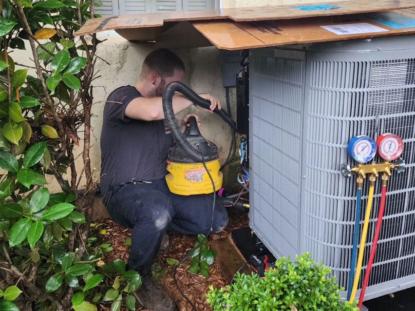 Woody team member installing AC unit outside